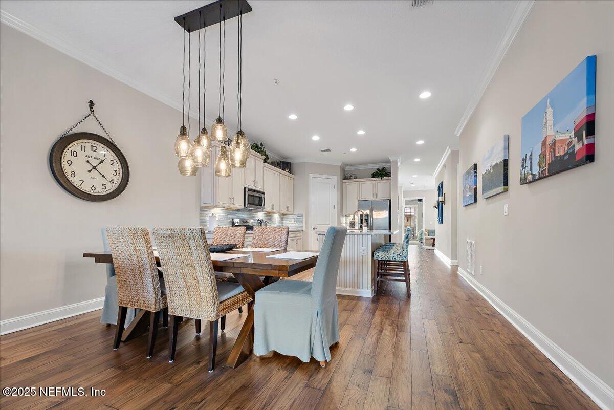95220 Summerwoods Circle, Unit 1205 Fernandina Beach, FL 32034 - Photo 16 of 32 a view of a dining area with furniture and wooden floor
