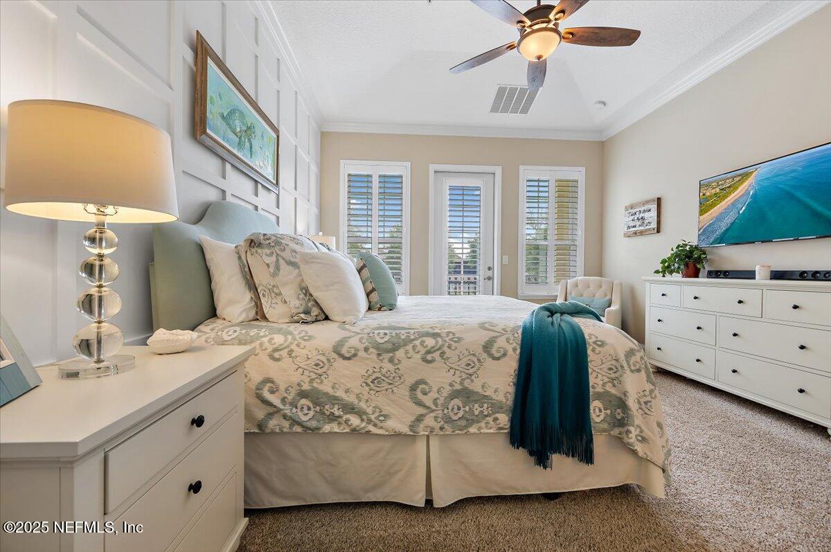 95220 Summerwoods Circle, Unit 1205 Fernandina Beach, FL 32034 - Photo 21 of 32 a spacious bedroom with a bed and a chandelier