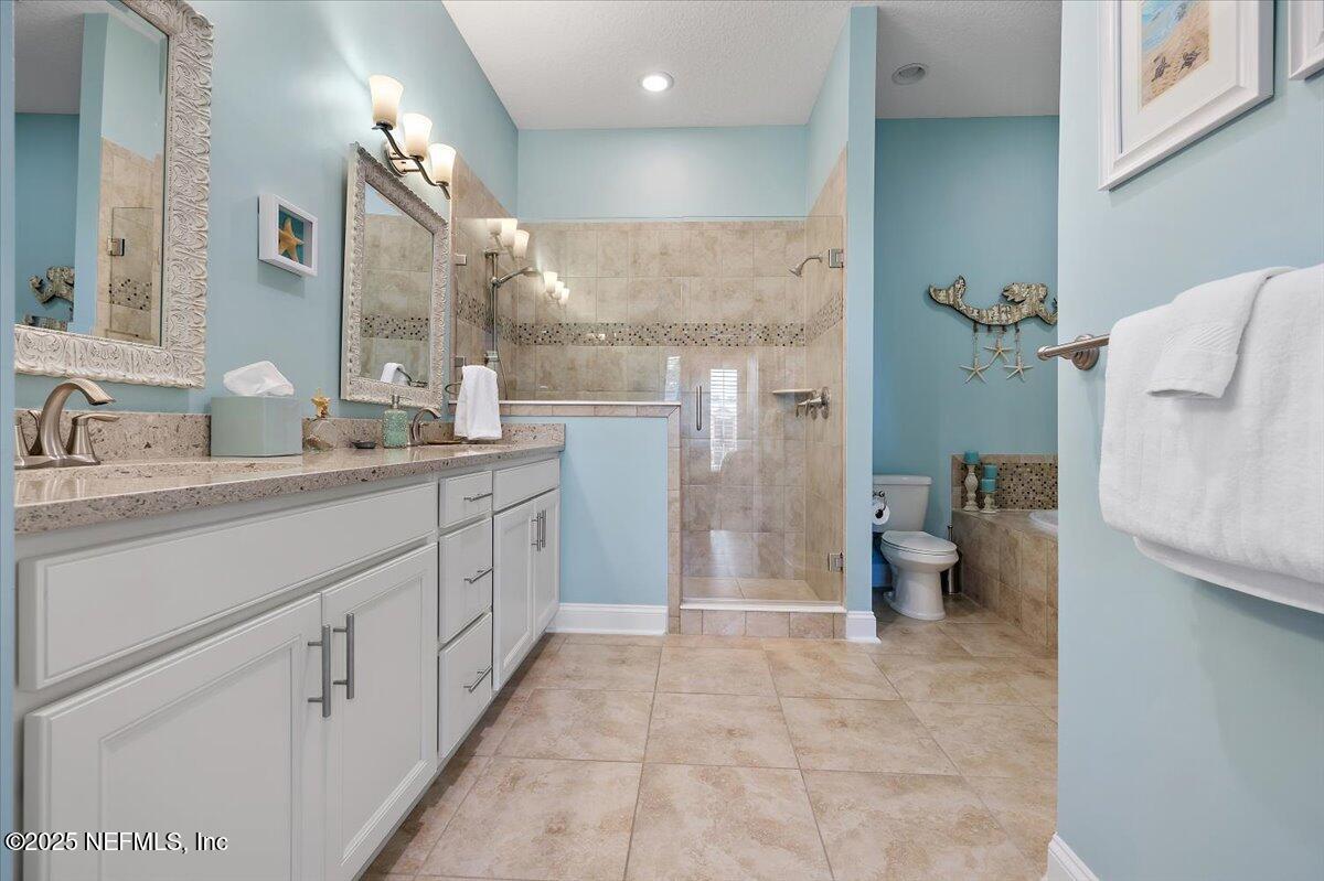 95220 Summerwoods Circle, Unit 1205 Fernandina Beach, FL 32034 - Photo 22 of 32 a spacious bathroom with a granite countertop sink a toilet and shower
