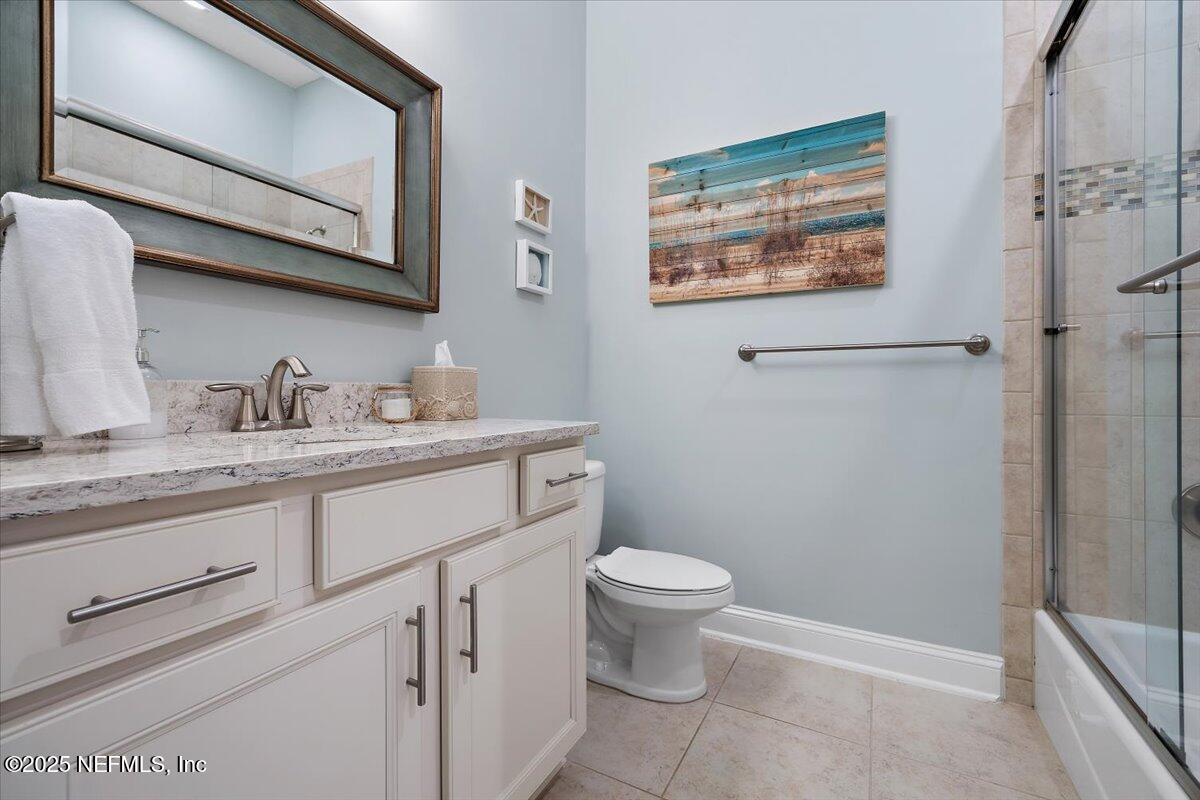 95220 Summerwoods Circle, Unit 1205 Fernandina Beach, FL 32034 - Photo 26 of 32 a bathroom with a granite countertop sink mirror vanity and toilet