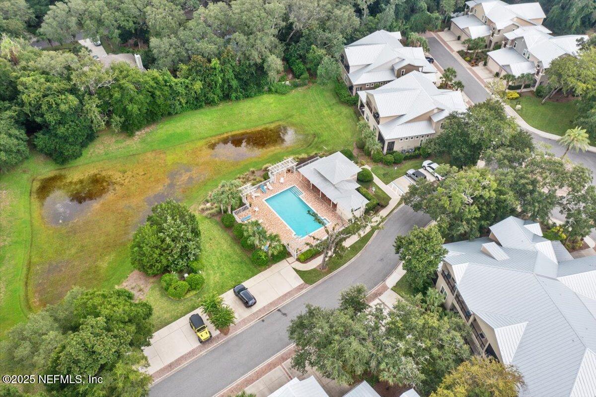 95220 Summerwoods Circle, Unit 1205 Fernandina Beach, FL 32034 - Photo 30 of 32 an aerial view of a house with a yard and lake view