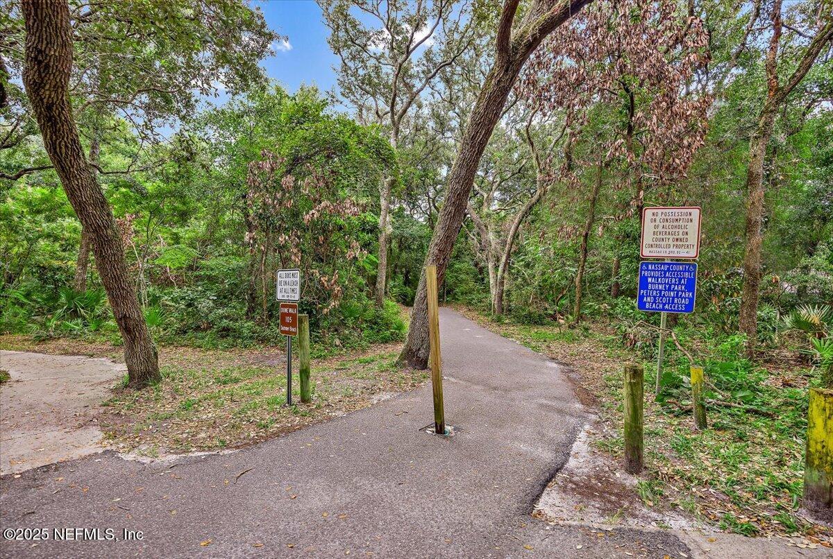 95220 Summerwoods Circle, Unit 1205 Fernandina Beach, FL 32034 - Photo 31 of 32 a road view with large trees