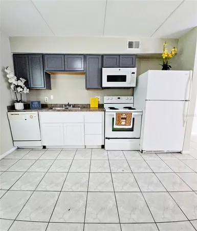 a kitchen with stainless steel appliances a stove a sink and a refrigerator