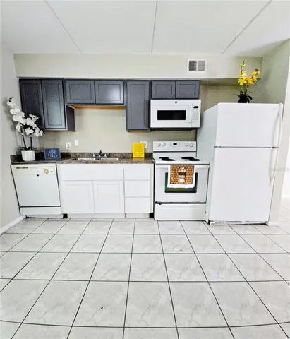 a kitchen with stainless steel appliances a stove a sink and a refrigerator