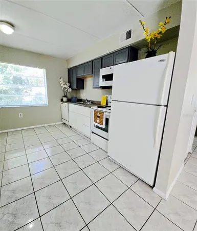 a kitchen with stainless steel appliances a refrigerator sink and microwave