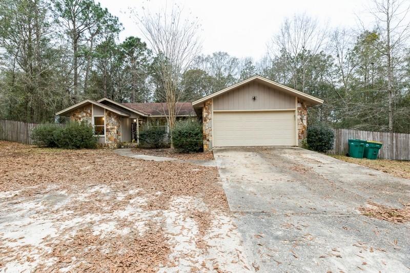 6124 Beasley Road Crestview, FL 32536 - Photo 1 of 20 a front view of a house with a yard and garage