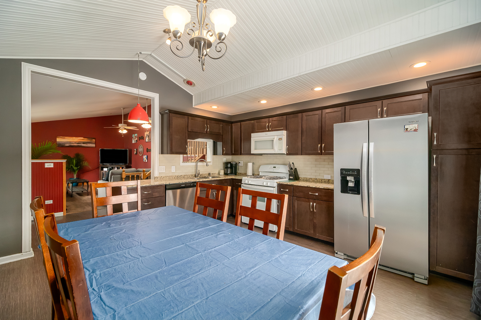 805 South Cooper Road New Lenox, IL 60451 - Photo 12 of 25 a kitchen with stainless steel appliances granite countertop a refrigerator a sink dishwasher a stove and a dining table with wooden floor