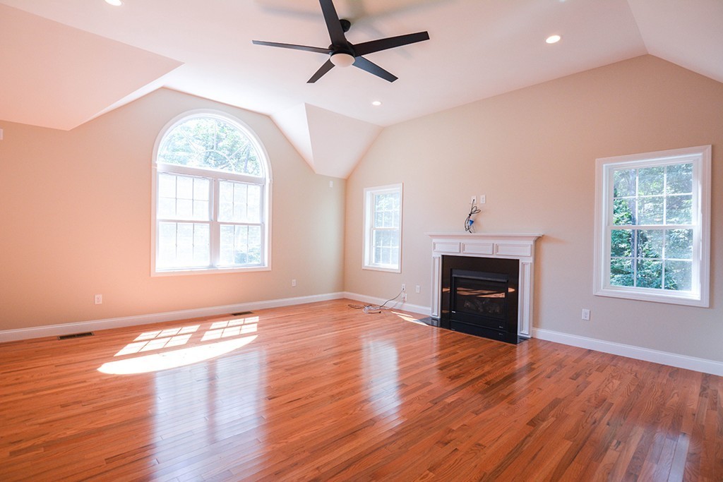 Lot 3 Tavern Road Groton, MA 01450 - Photo 5 of 25 an empty room with windows fireplace and wooden floor