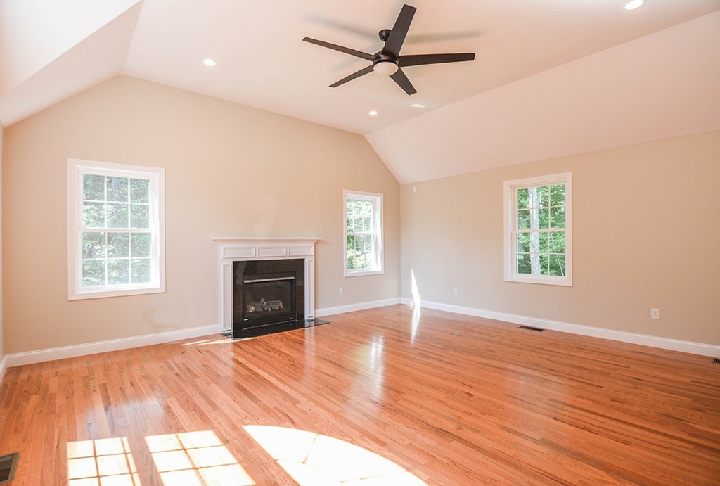 Lot 3 Tavern Road Groton, MA 01450 - Photo 6 of 25 an empty room with wooden floor fireplace and windows