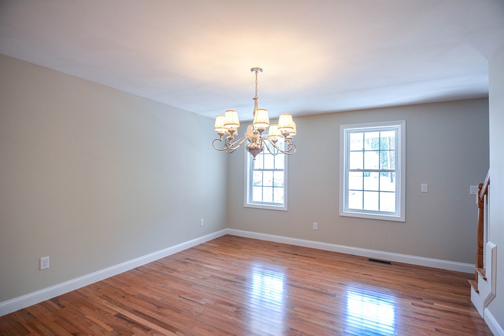 Lot 3 Tavern Road Groton, MA 01450 - Photo 9 of 25 a view of an empty room with wooden floor and chandelier