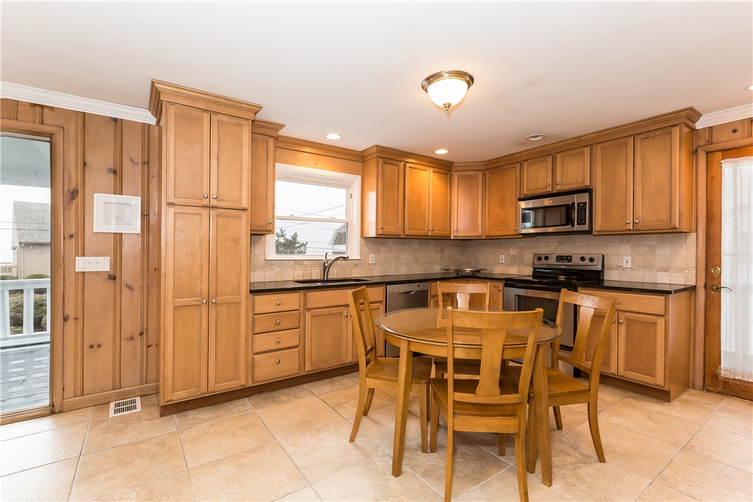 26 Dunes Road Narragansett, RI 02882 - Photo 11 of 40 EAT IN KITCHEN LEADING TO OVERSIZED DECK FROM EITHER THE FRENCH DOORS OR THE SIDE DOOR