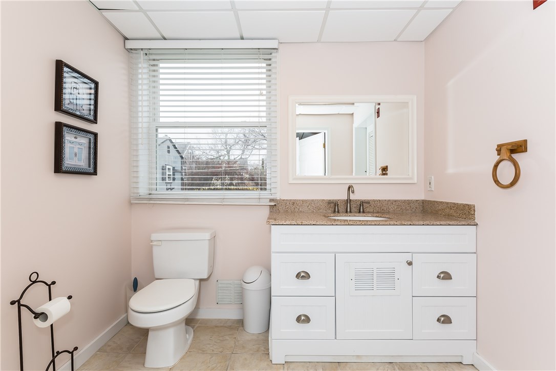 26 Dunes Road Narragansett, RI 02882 - Photo 27 of 40 THIS UPDATED, FULL BATHROOM FEATURES SILESTONE COUNTERS, WHITE SHAKER CABINETRY, A OVERSIZED STALL SHOWER, AND CERMAIC TILE.