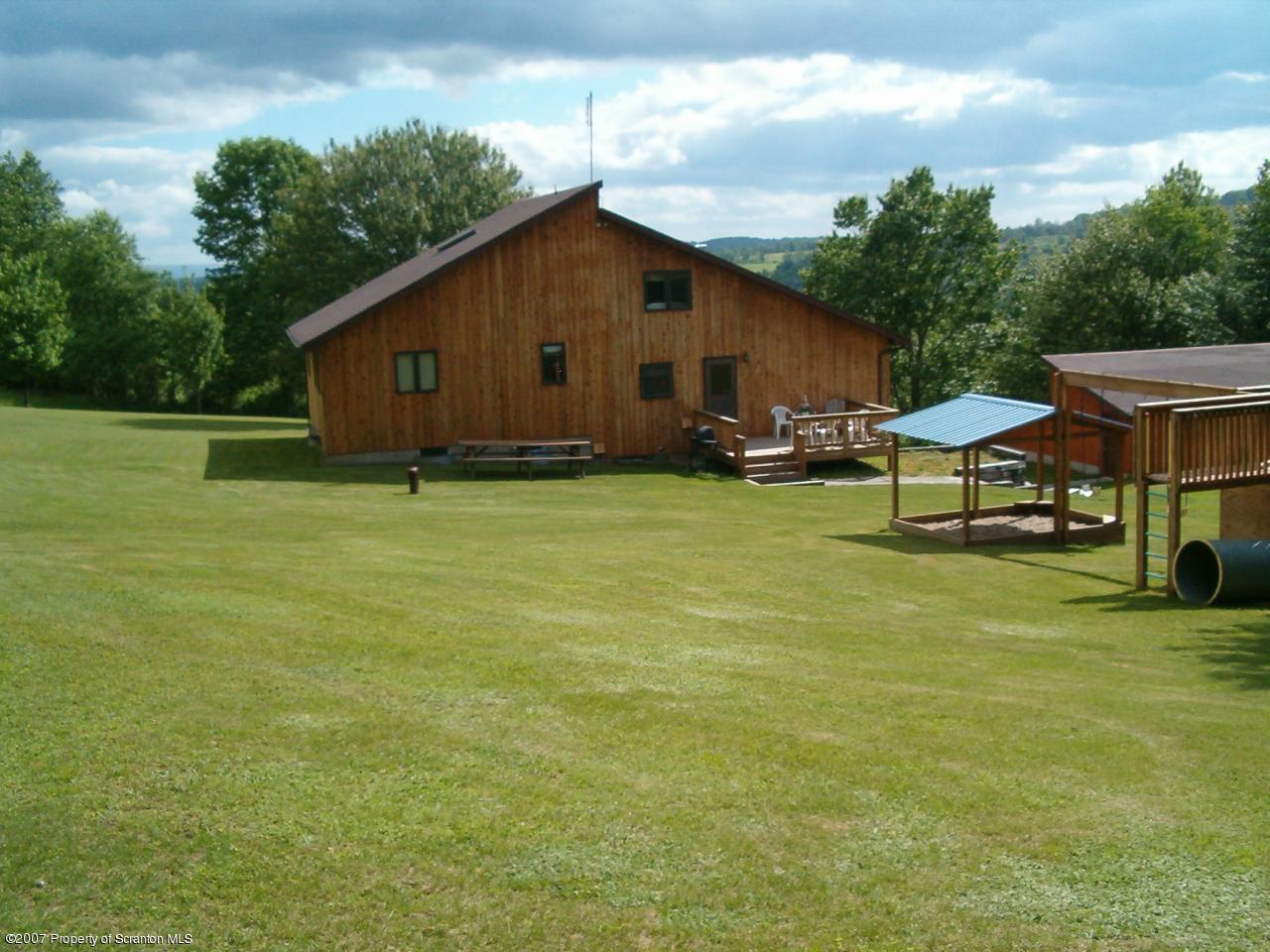 117 Elk Lake Road Springville, PA 18844 - Photo 12 of 15 a swimming pool with outdoor seating and yard