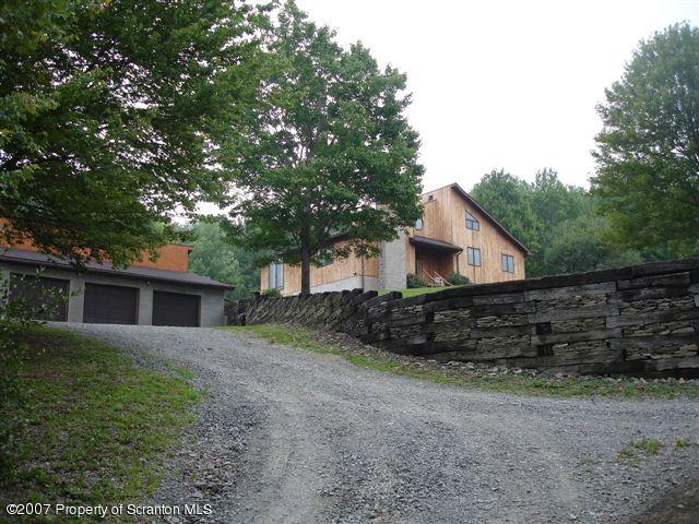 117 Elk Lake Road Springville, PA 18844 - Photo 2 of 15 a front view of a house with a yard