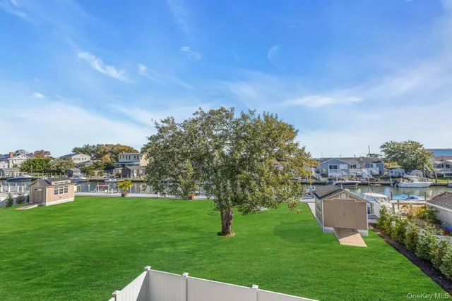 a view of an house with backyard and a patio