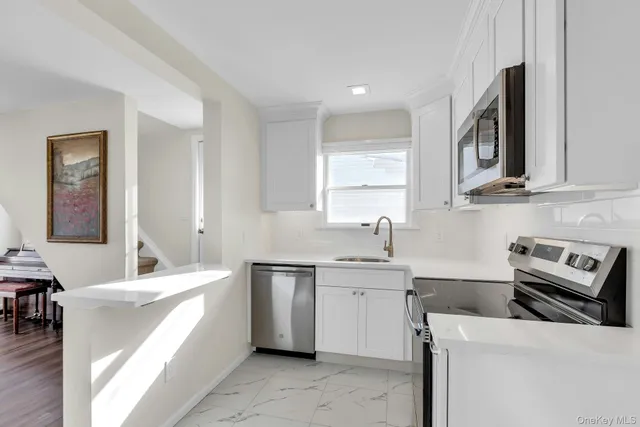 a kitchen with a sink and wooden cabinets