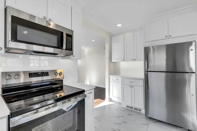 a kitchen with a refrigerator stove and microwave