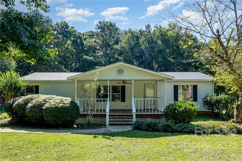 600 East Sandy Ridge Road Monroe, NC 28112 - Photo 1 of 27 a front view of a house with a garden