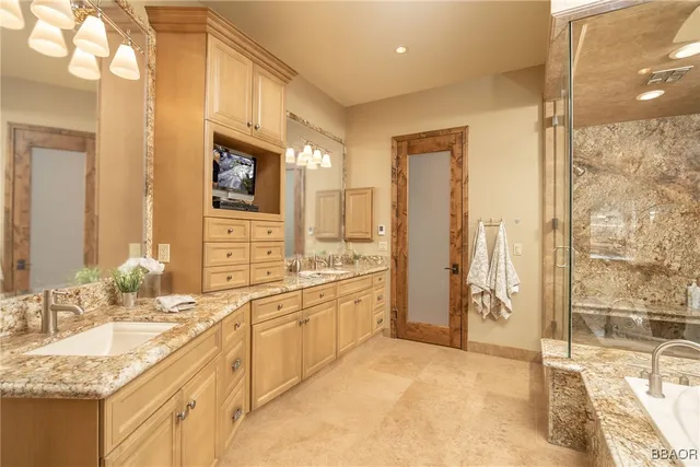 a spacious bathroom with sink shower and bathtub