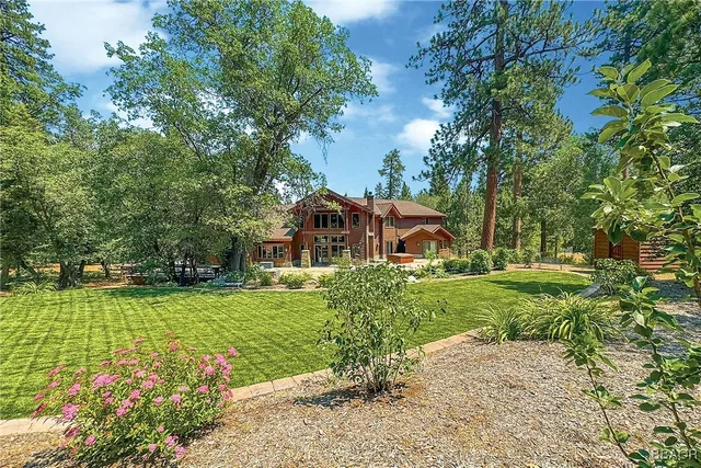a view of a house with a garden and pathway