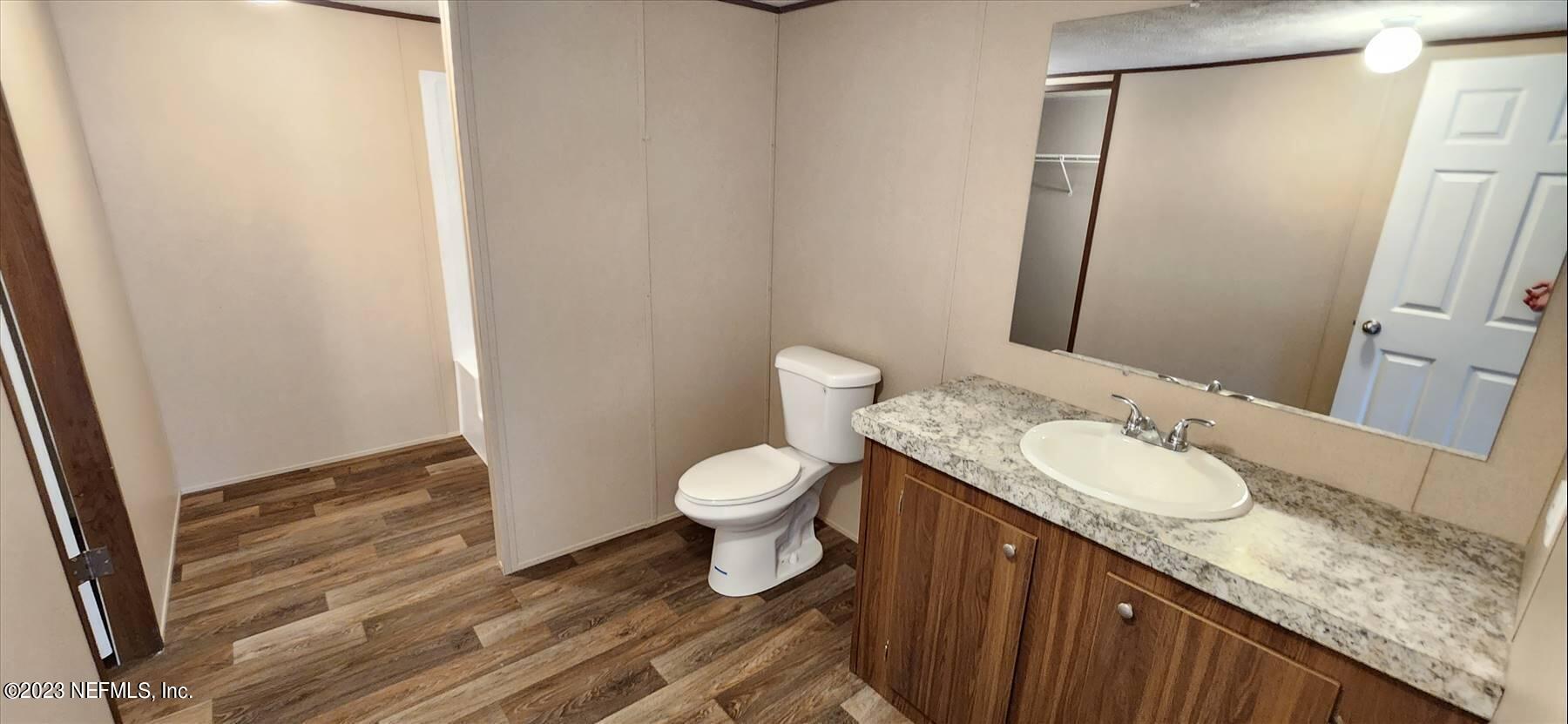 134 Juniper Road Georgetown, FL 32139 - Photo 11 of 20 a bathroom with a granite countertop sink toilet and shower