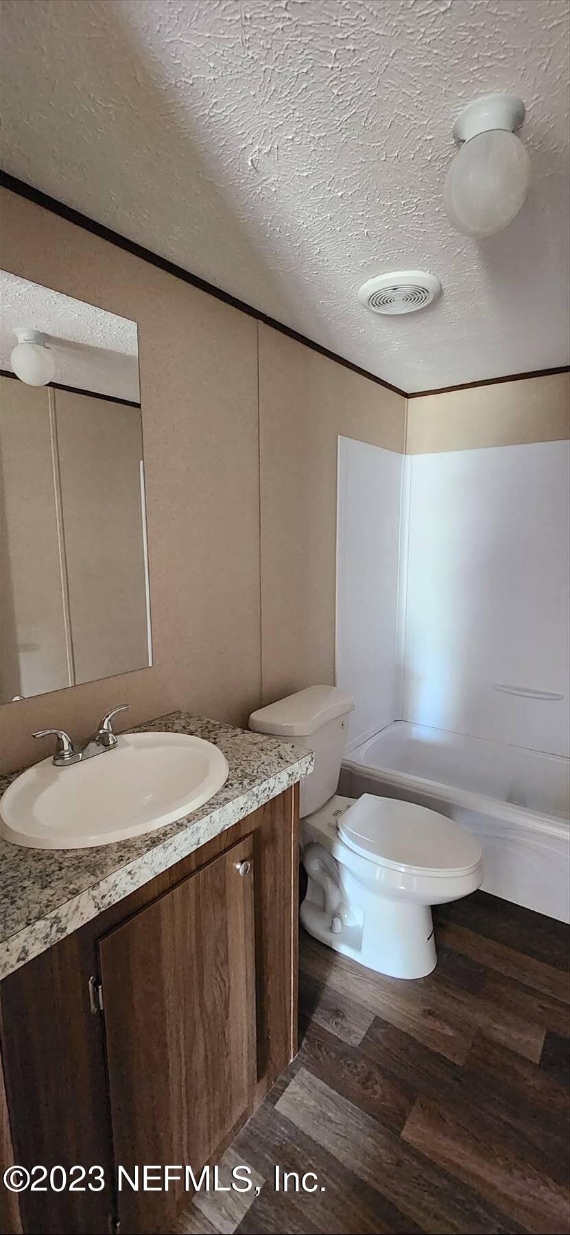 134 Juniper Road Georgetown, FL 32139 - Photo 14 of 20 a bathroom with a granite countertop sink a toilet and a mirror