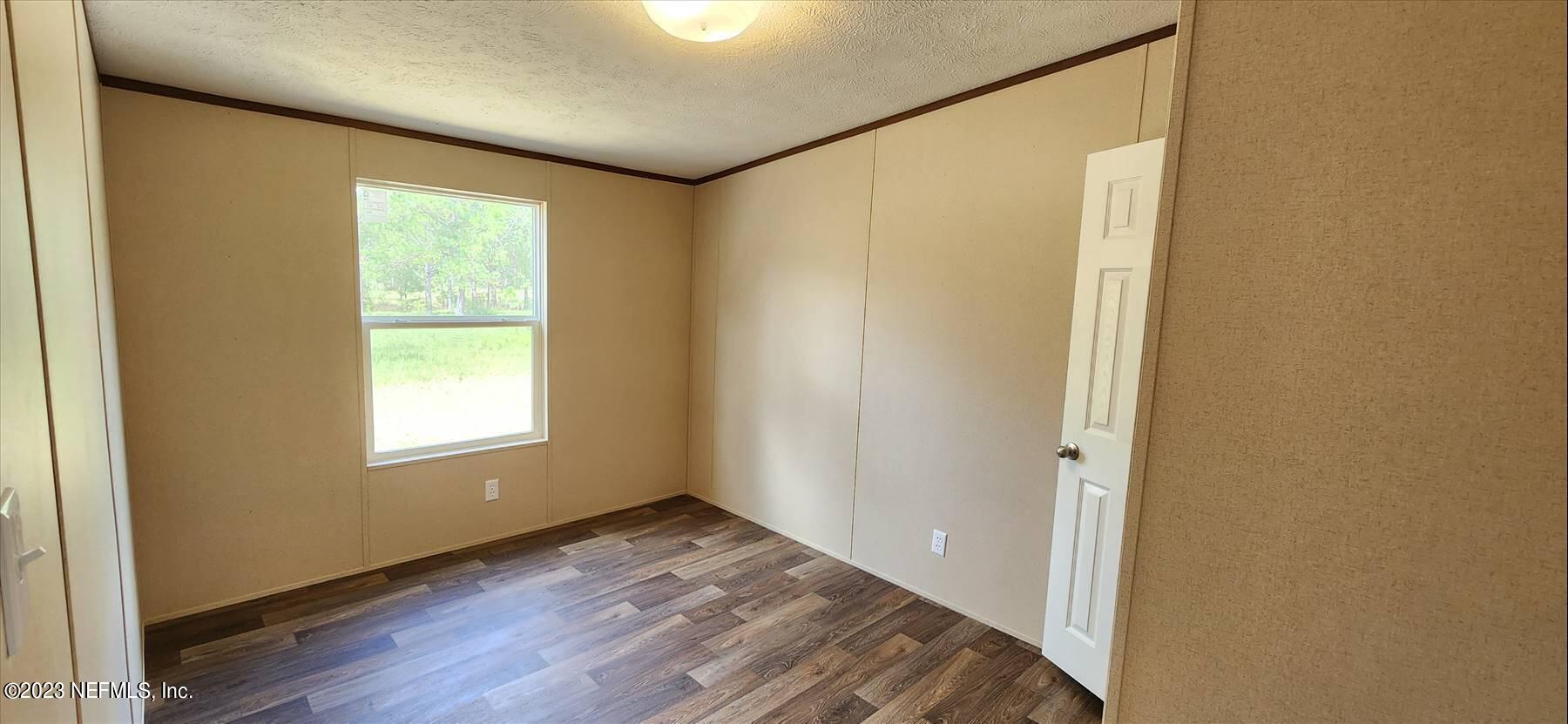 134 Juniper Road Georgetown, FL 32139 - Photo 18 of 20 a view of an empty room with wooden floor and a window