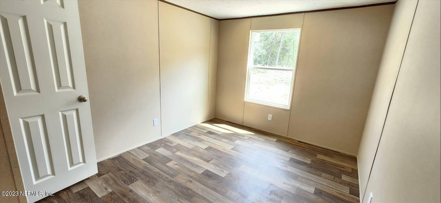 134 Juniper Road Georgetown, FL 32139 - Photo 19 of 20 a view of an empty room with wooden floor and a window