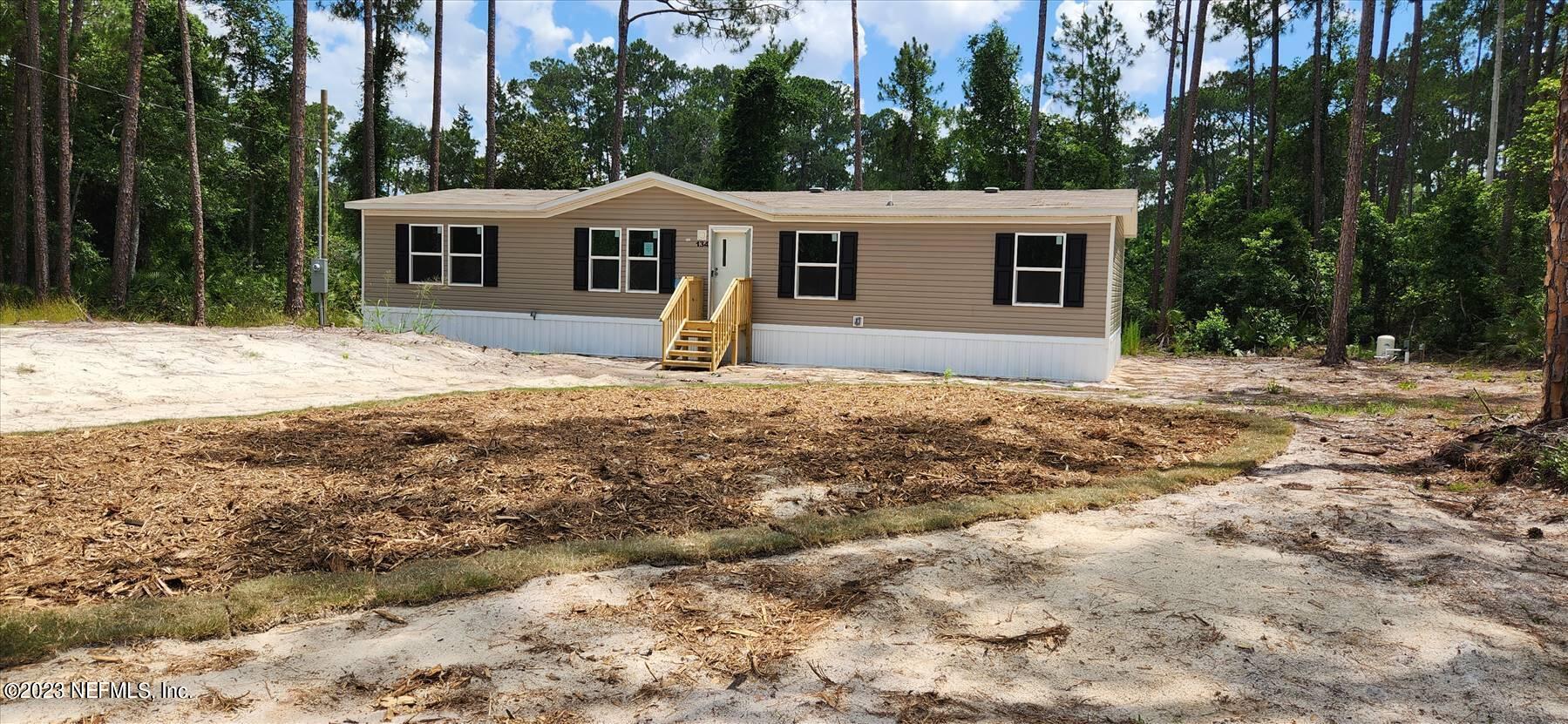 134 Juniper Road Georgetown, FL 32139 - Photo 2 of 20 a front view of a house with a yard covered with trees