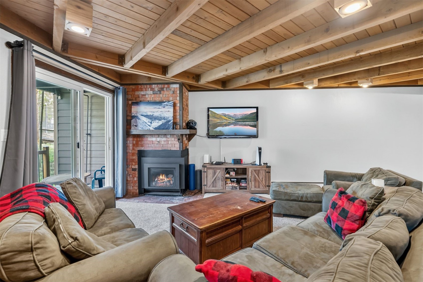 8100 Ryan Gulch Road, Unit 106 Wildernest, CO 80498 - Photo 8 of 43 a living room with furniture and a fireplace