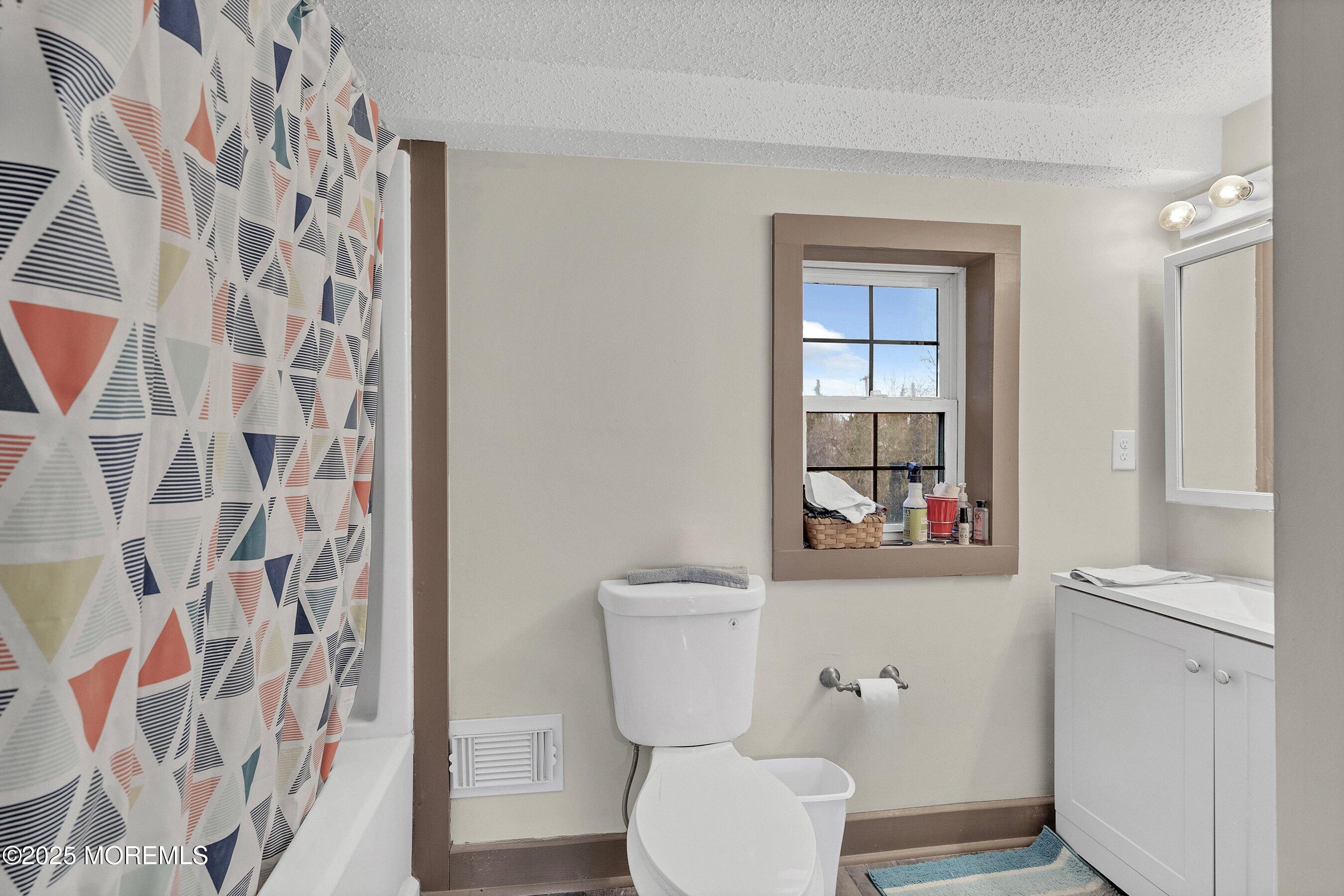 Main Street Barnegat, NJ 08005 - Photo 15 of 26 a bathroom with a toilet and a shower curtain