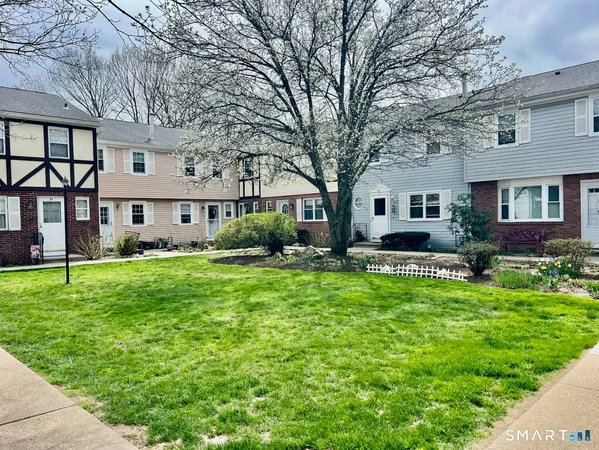 a front view of a house with a yard table and chairs