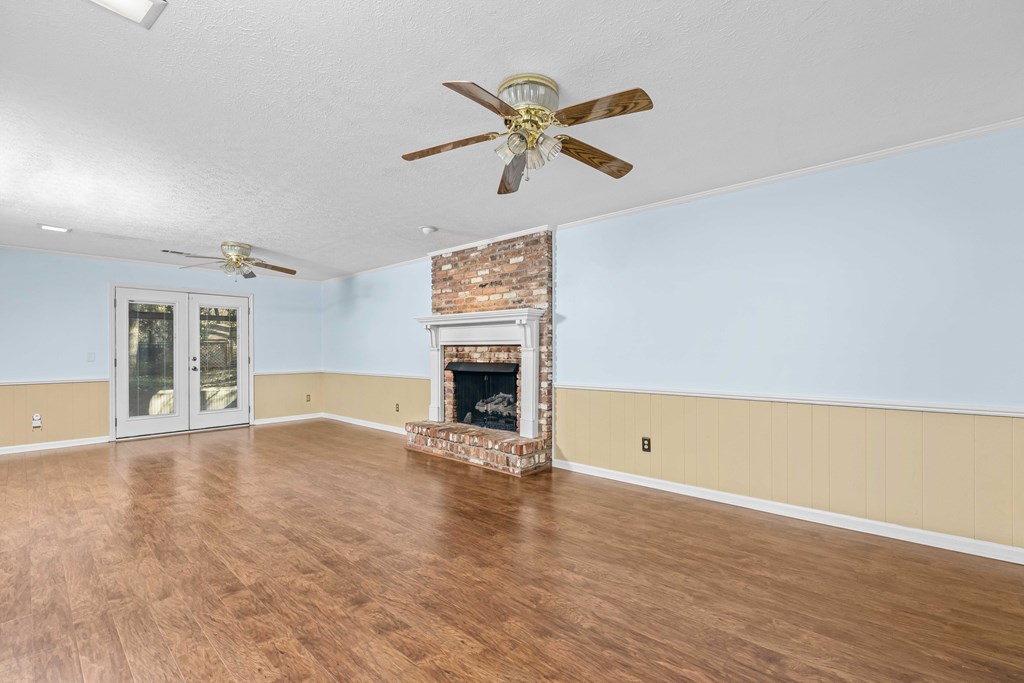 8535 Jackson Road Midland, GA 31820 - Photo 18 of 69 Gas fireplace in living room, opens to sunroom