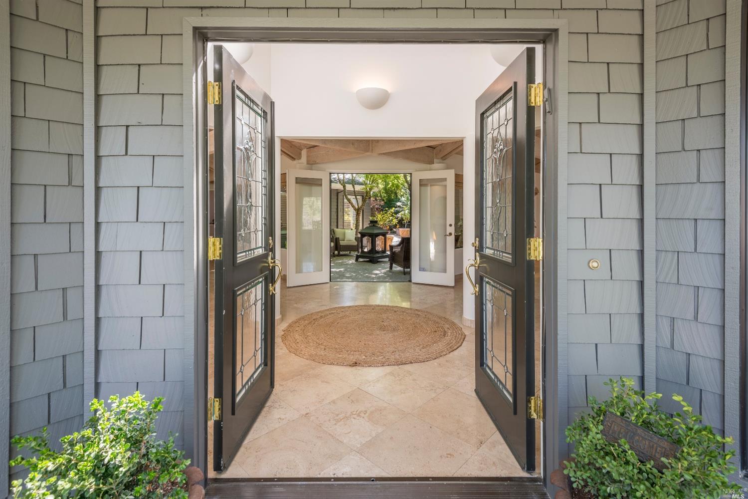 a view of a porch with a table and potted plants