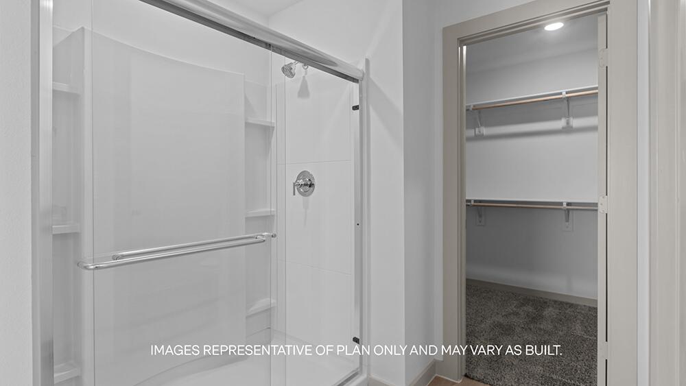 7445 9th Street Lubbock, TX 79416 - Photo 11 of 16 a bathroom with a glass shower door
