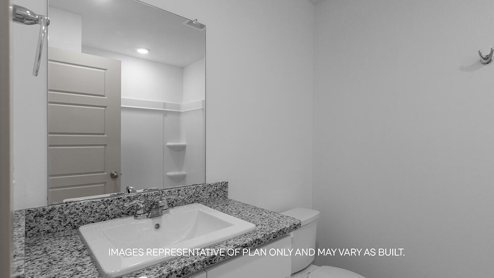 7445 9th Street Lubbock, TX 79416 - Photo 15 of 16 a bathroom with a tub and sink