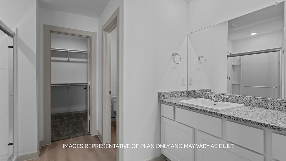 7445 9th Street Lubbock, TX 79416 - Photo 10 of 16 a bathroom with a granite countertop sink and a mirror