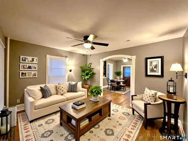 a living room with furniture and a large mirror