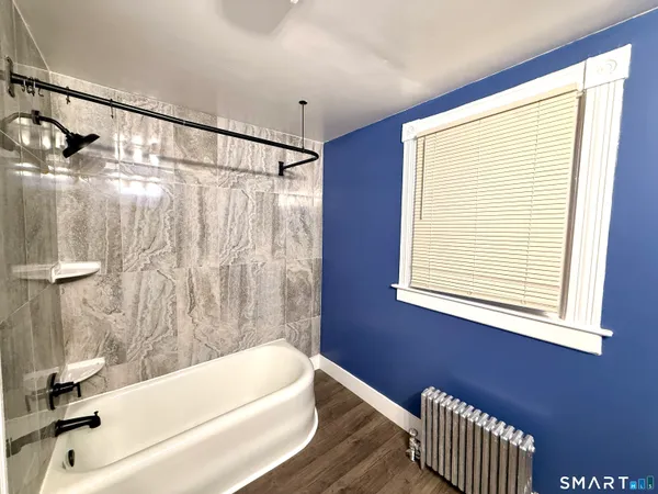 a bathroom with a bathtub and a shower