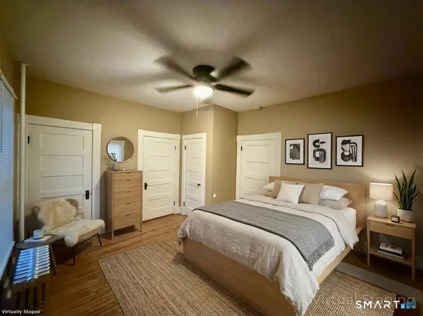 a spacious bedroom with a bed and a chandelier