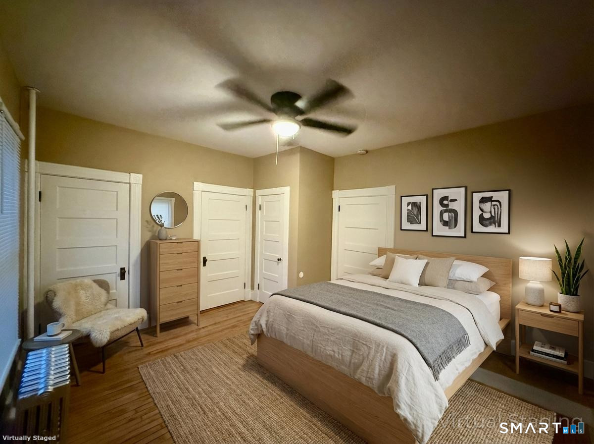 80 North Street Windham, CT 06226 - Photo 5 of 16 a spacious bedroom with a bed and a chandelier