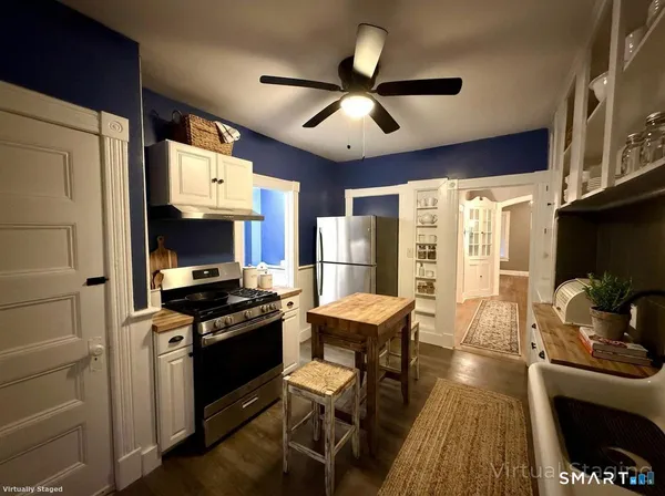 a kitchen with stainless steel appliances a stove a sink dishwasher and a refrigerator