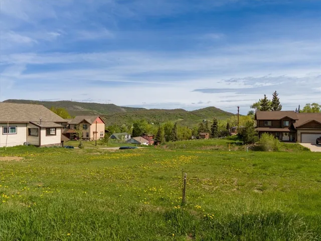 a balcony with grassy field and mountains