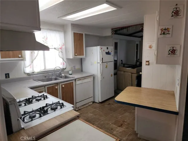 a kitchen with a stove a refrigerator and a stove