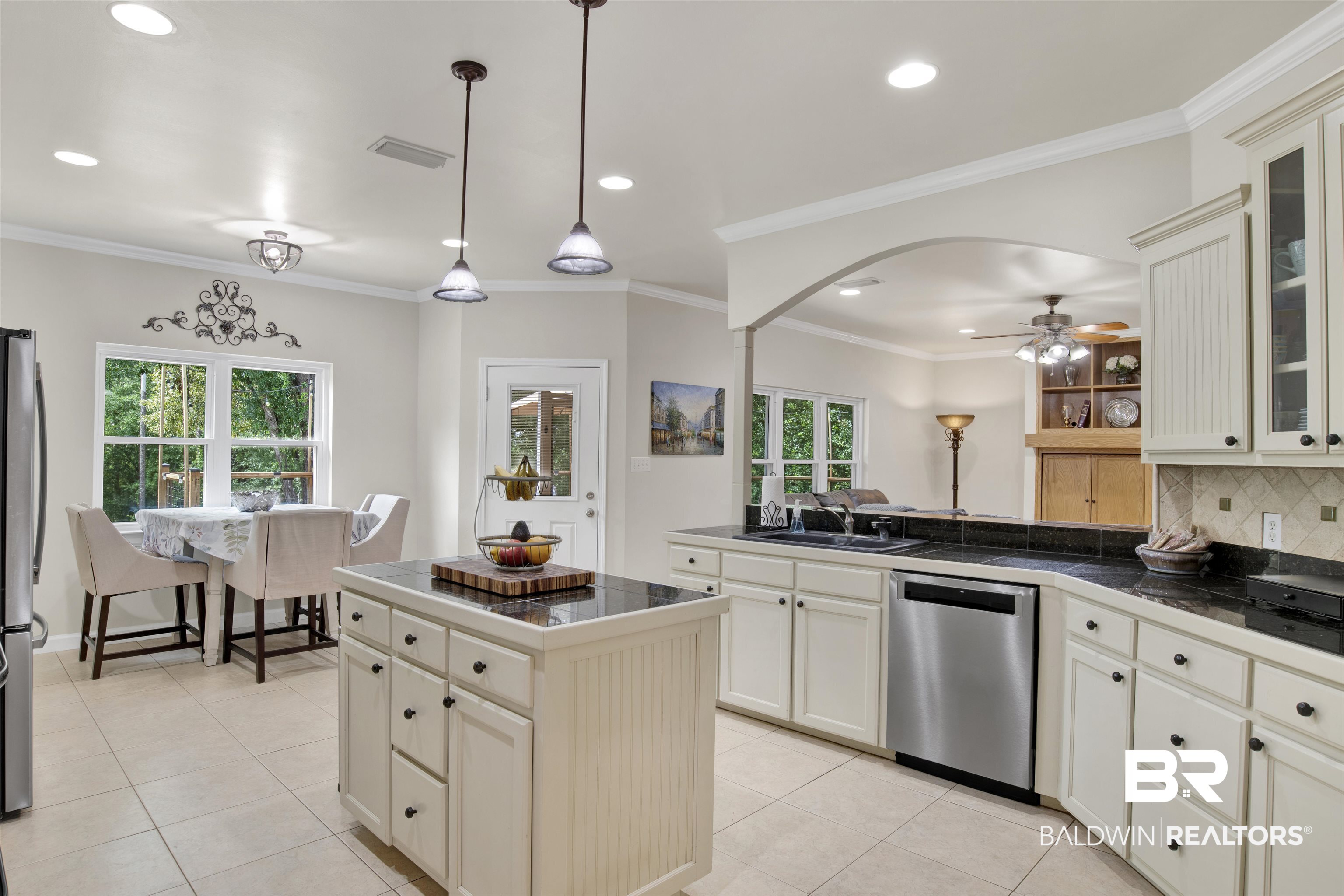 638 Southern Way Daphne, AL 36527 - Photo 8 of 26 Kitchen featuring light tile patterned floors, a wealth of natural light, decorative backsplash, and stainless steel appliances