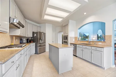 a large kitchen with stainless steel appliances lots of counter top space