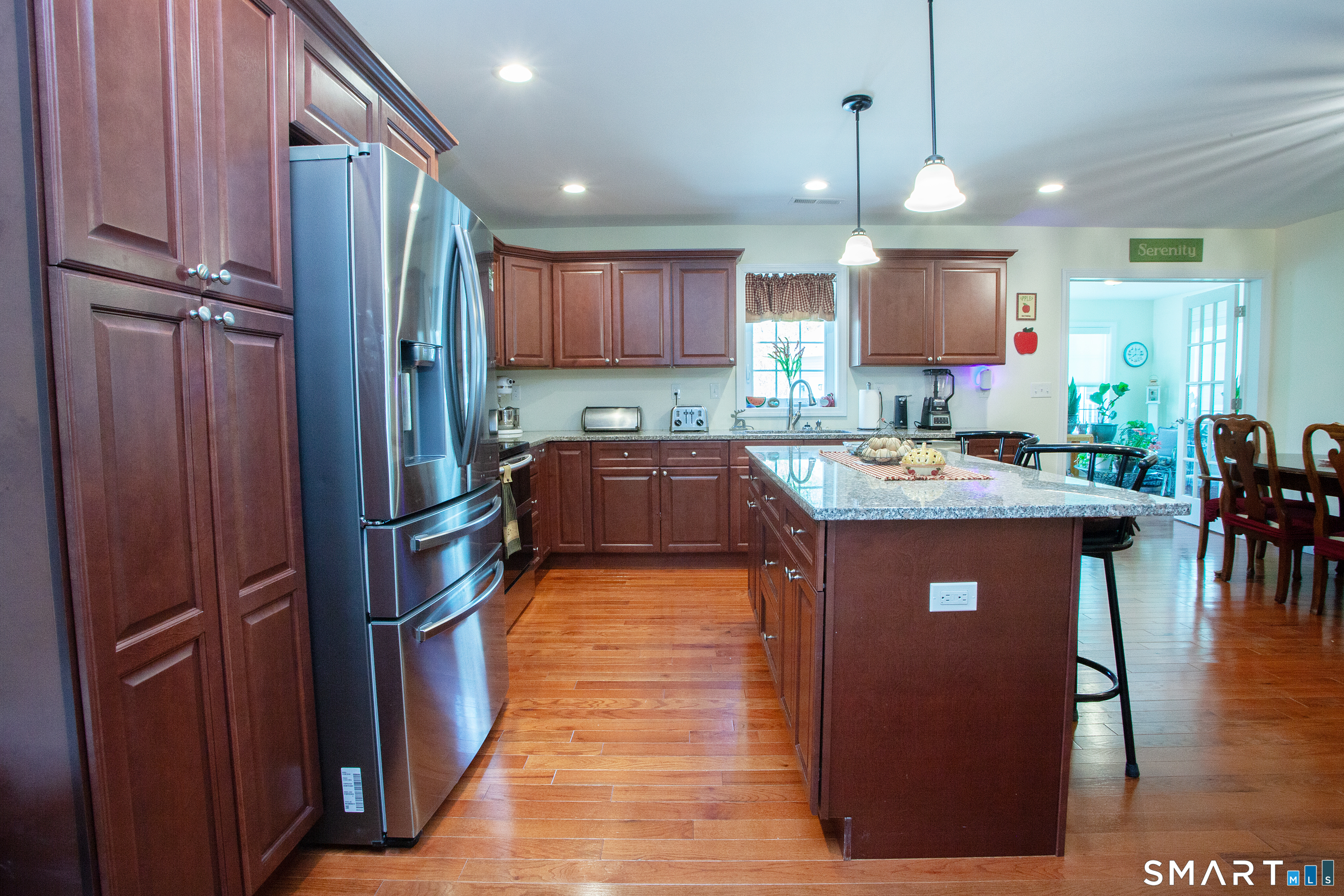 3 Hannah Way Torrington, CT 06790 - Photo 6 of 23 a kitchen with stainless steel appliances granite countertop a refrigerator a sink dishwasher a stove and a dining table with wooden floor
