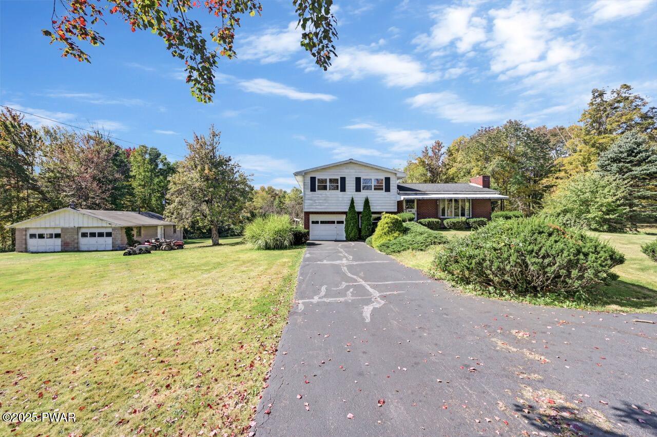 100 Spring Hill Road Moscow, PA 18444 - Photo 68 of 101 a front view of a house with a yard and trees
