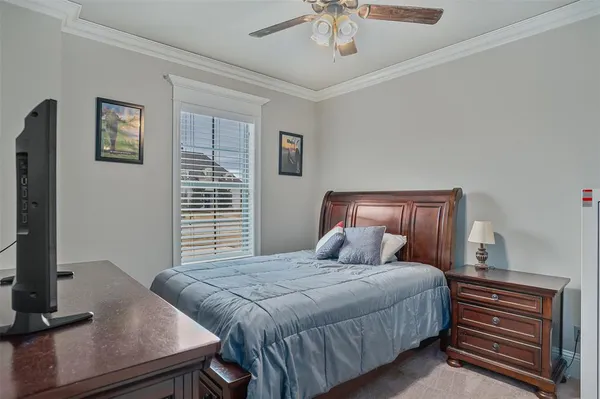 a bedroom with a large bed and a flat tv screen on a dresser
