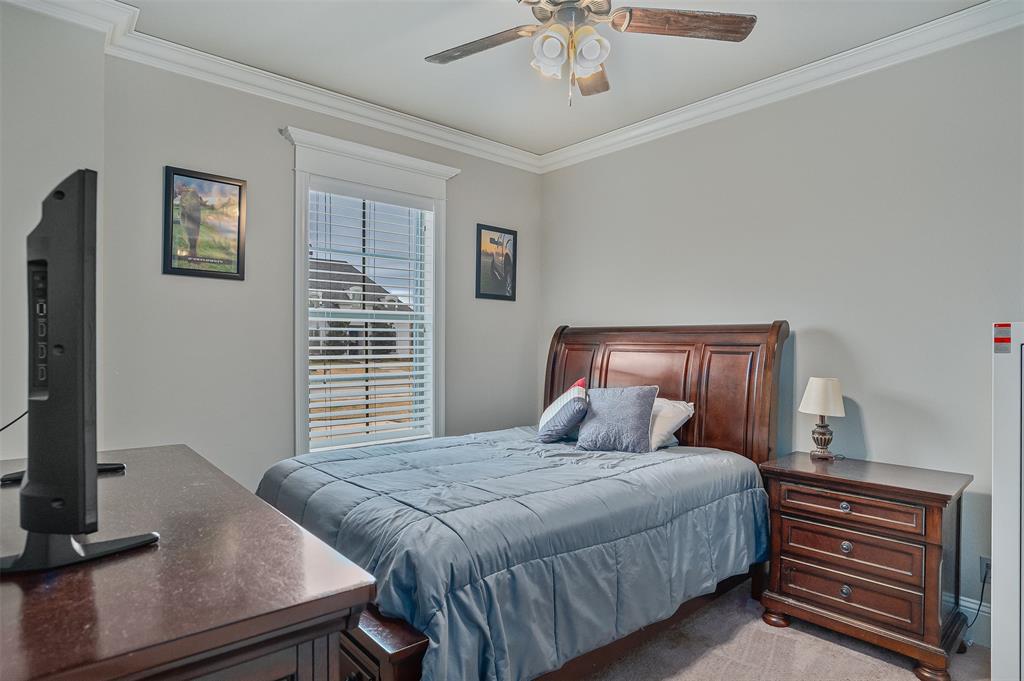 106 Pear Tree Lane Benton, LA 71006 - Photo 17 of 26 a bedroom with a large bed and a flat tv screen on a dresser